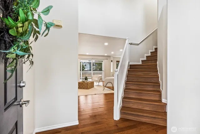 a view of entryway and hall with wooden floor