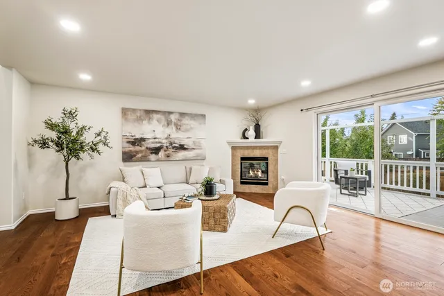 a living room with furniture a lamp a potted plant and a large window