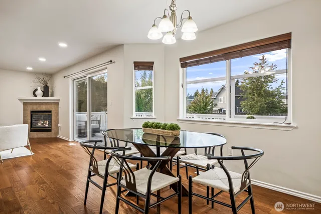 a dining room with furniture a chandelier and wooden floor