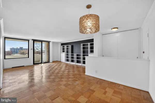 a view of an empty room with a empty space and a window