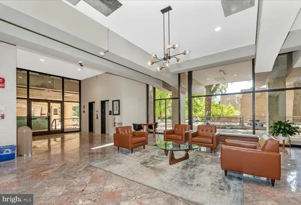 a living room with furniture and a chandelier