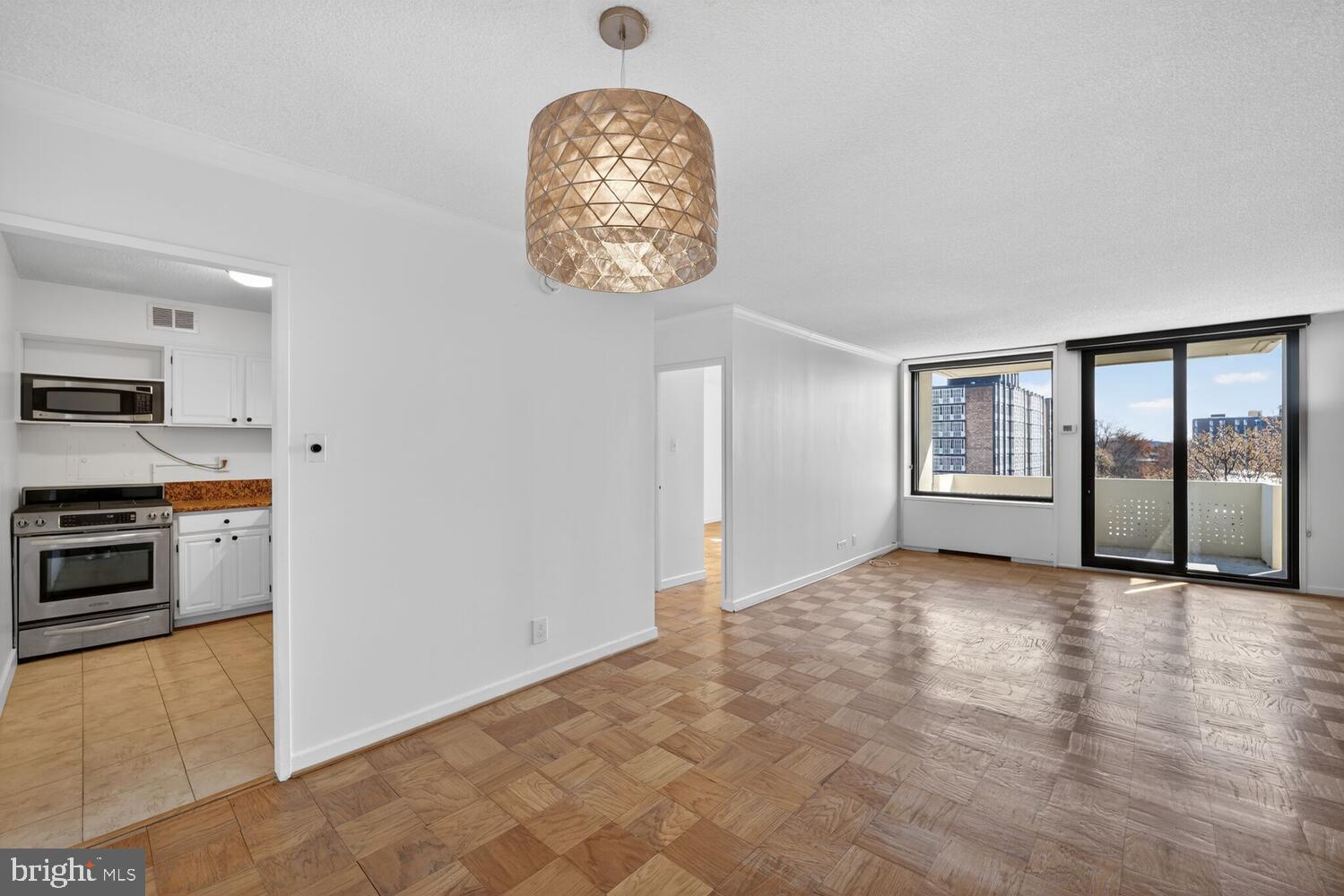 240 M Street Southwest, Unit E406 Washington, DC 20024 - Photo 37 of 38 a view of a kitchen with stainless steel appliances wooden floor and a window