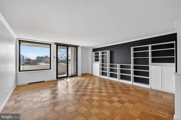 a view of a kitchen with stainless steel appliances wooden floor and a window
