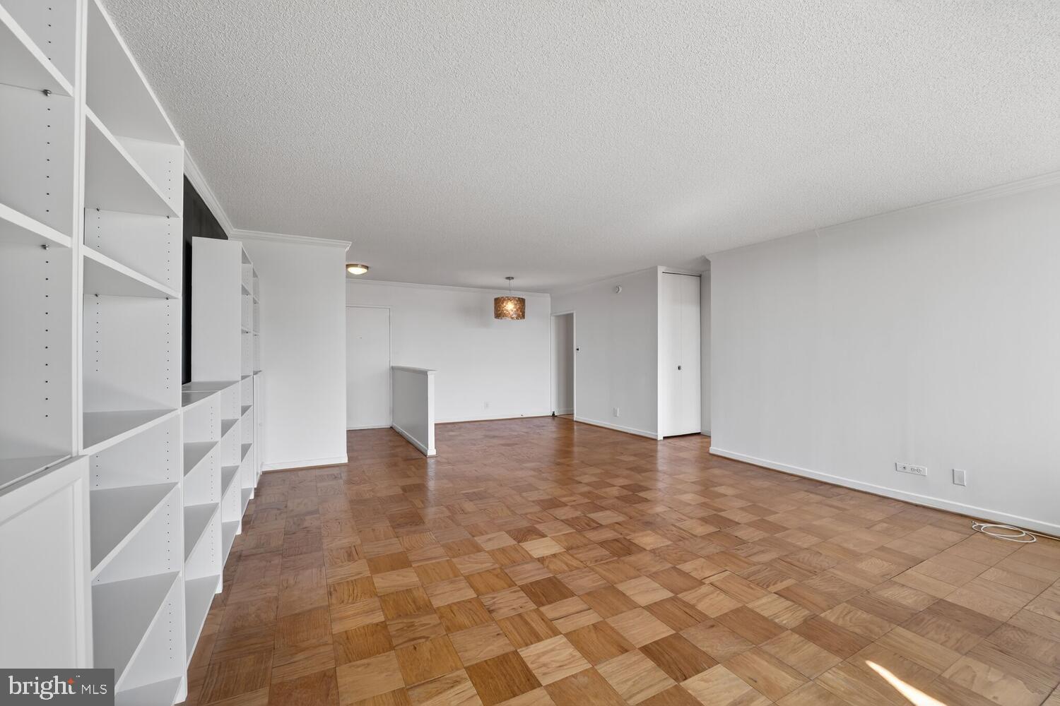 240 M Street Southwest, Unit E406 Washington, DC 20024 - Photo 8 of 38 a view of an empty room with wooden floor