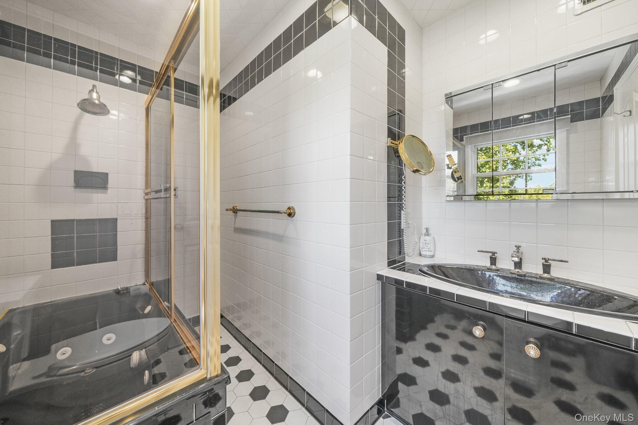 29 Chatfield Road Bronxville, NY 10708 - Photo 13 of 27 Bathroom featuring tile walls, a shower stall, vanity, a whirlpool tub, and tile patterned floors