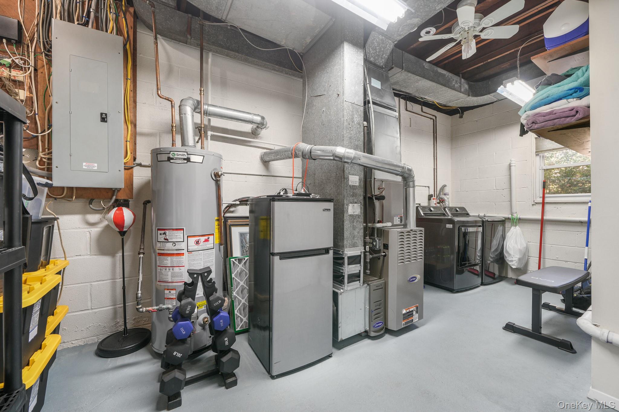 29 Chatfield Road Bronxville, NY 10708 - Photo 18 of 27 Utilities with electric panel, gas water heater, heating unit, and washer and dryer