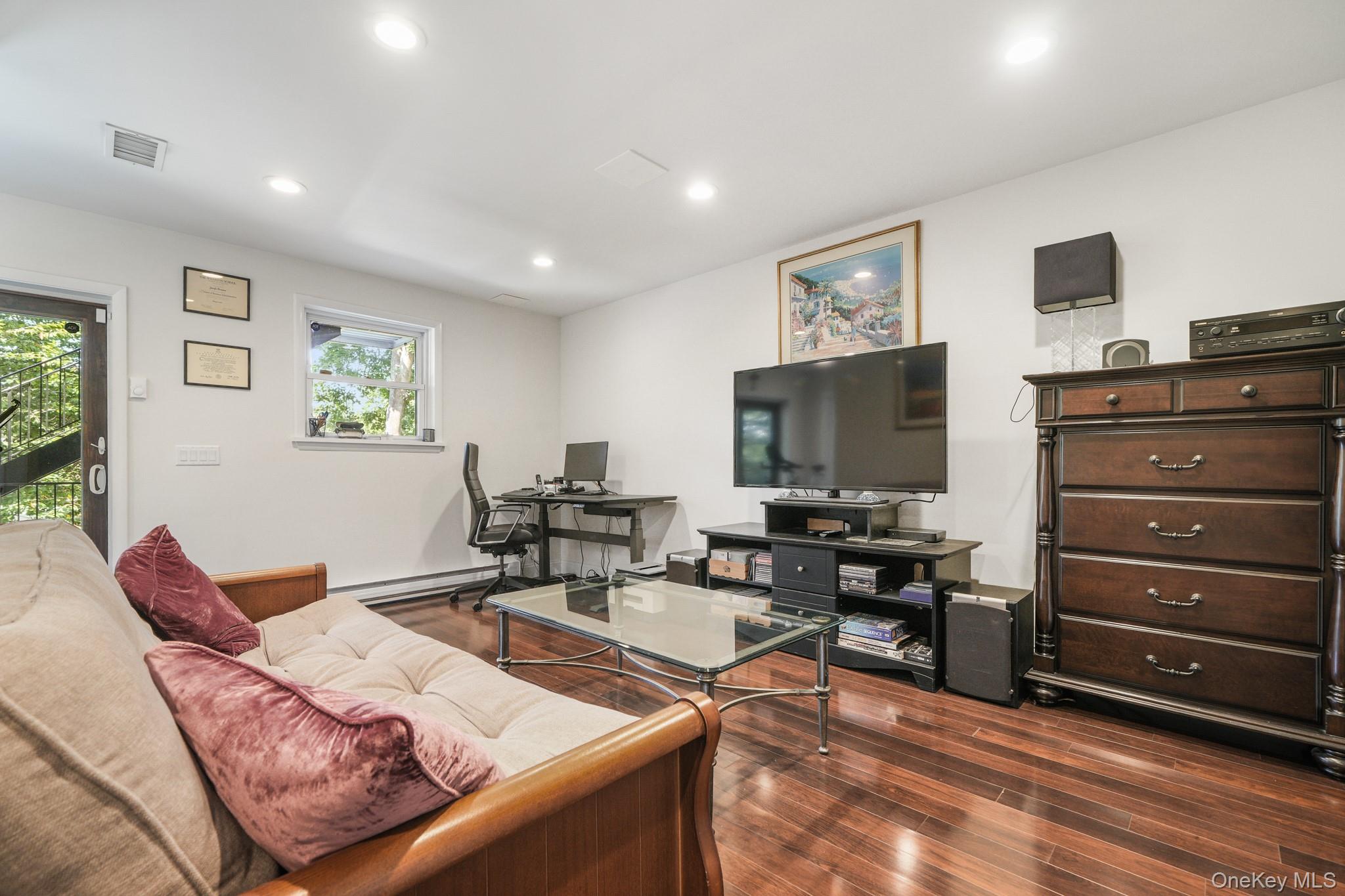 29 Chatfield Road Bronxville, NY 10708 - Photo 19 of 27 Living area with a desk, dark wood finished floors, recessed lighting, and a baseboard heating unit