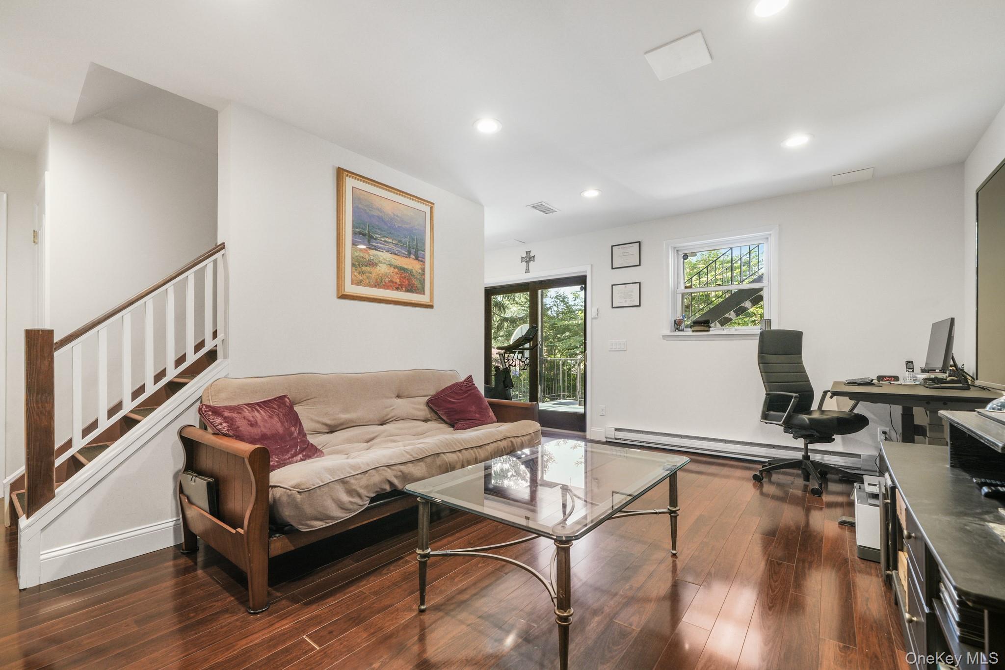 29 Chatfield Road Bronxville, NY 10708 - Photo 20 of 27 Living area featuring a desk, dark wood-type flooring, recessed lighting, baseboard heating, and stairs