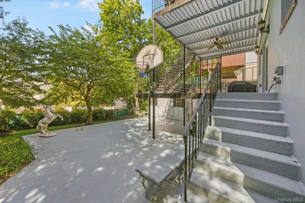 a view of a pathway of a building with a tree in the background