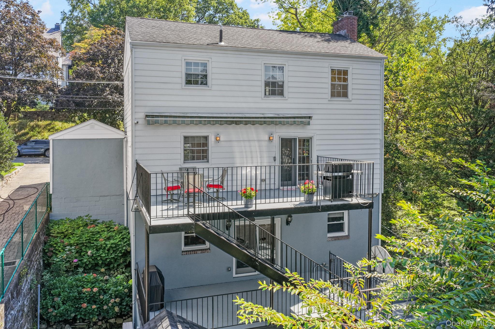 29 Chatfield Road Bronxville, NY 10708 - Photo 24 of 27 Rear view of house featuring stairway, a chimney, roof with shingles, and a balcony