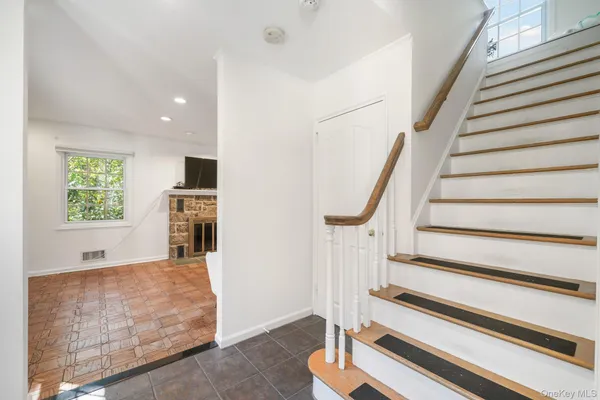 a view of entryway and hall with wooden floor