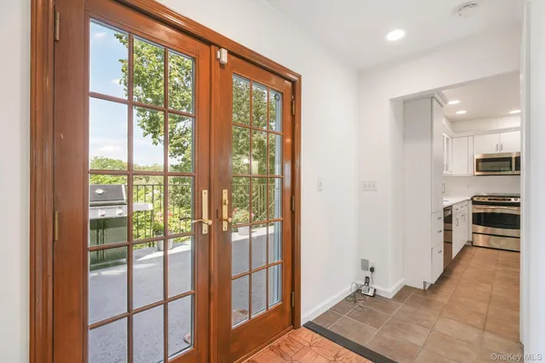 a view of a hallway with wooden floor and windows