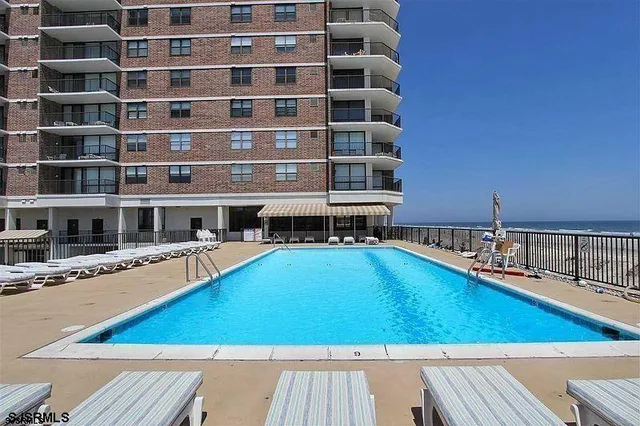 a view of a swimming pool with a lounge chairs