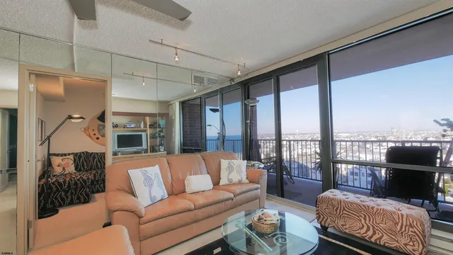 a living room with furniture and a floor to ceiling window