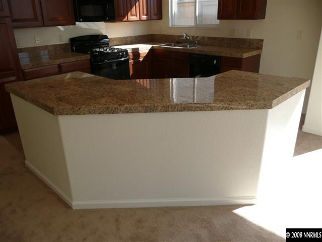 10753 Misty Meadows Drive, Unit 59 Reno, NV 89521 - Photo 3 of 9 a kitchen with a sink and cabinets