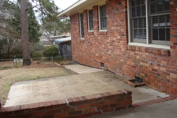 a view of a backyard with table and chairs