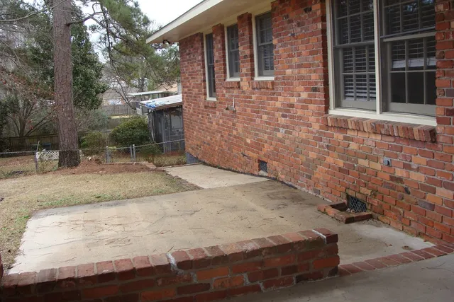 a view of a backyard with table and chairs