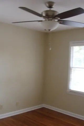 a view of a small space with wooden floor and a window