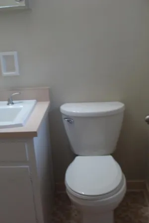 a white toilet sitting next to a bathroom sink
