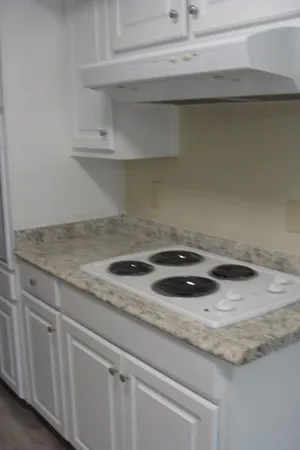 a stove top oven sitting inside of a kitchen