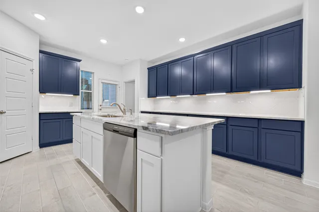 a kitchen with a sink and wooden cabinets