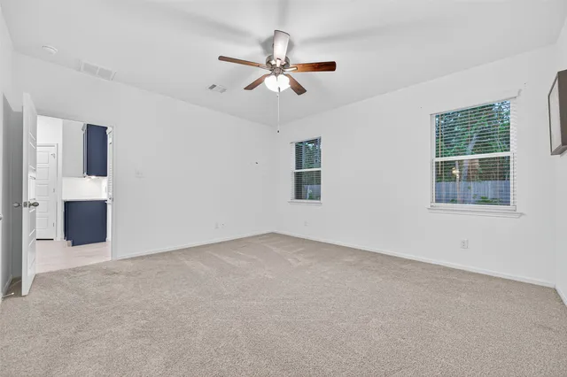 a view of a livingroom with a ceiling fan and window