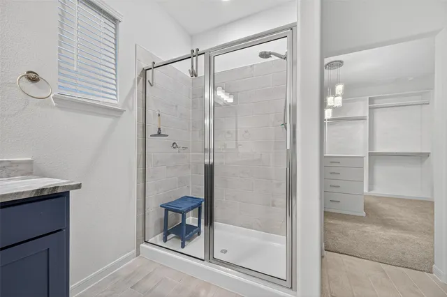 a bathroom with a shower and a sink