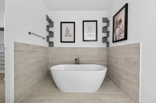 a white bath tub sitting in a bathroom