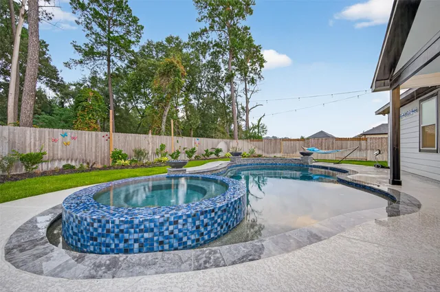 a view of a swimming pool with a yard