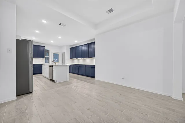 a view of kitchen with refrigerator stove microwave and cabinets