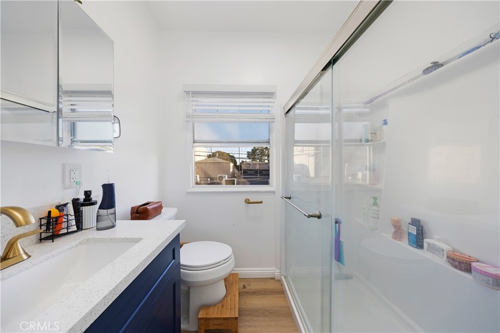 28 Argonne Avenue Long Beach, CA 90803 - Photo 13 of 20 a bathroom with a sink a toilet and shower curtain