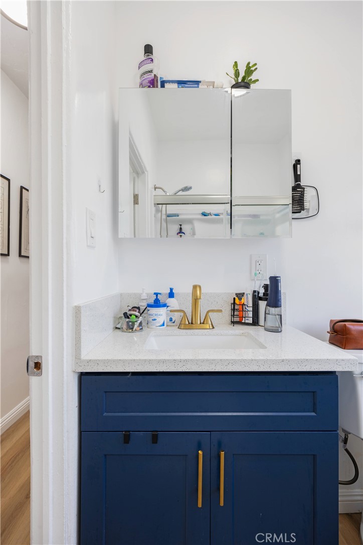 28 Argonne Avenue Long Beach, CA 90803 - Photo 14 of 20 a sink with cabinets and wooden floor