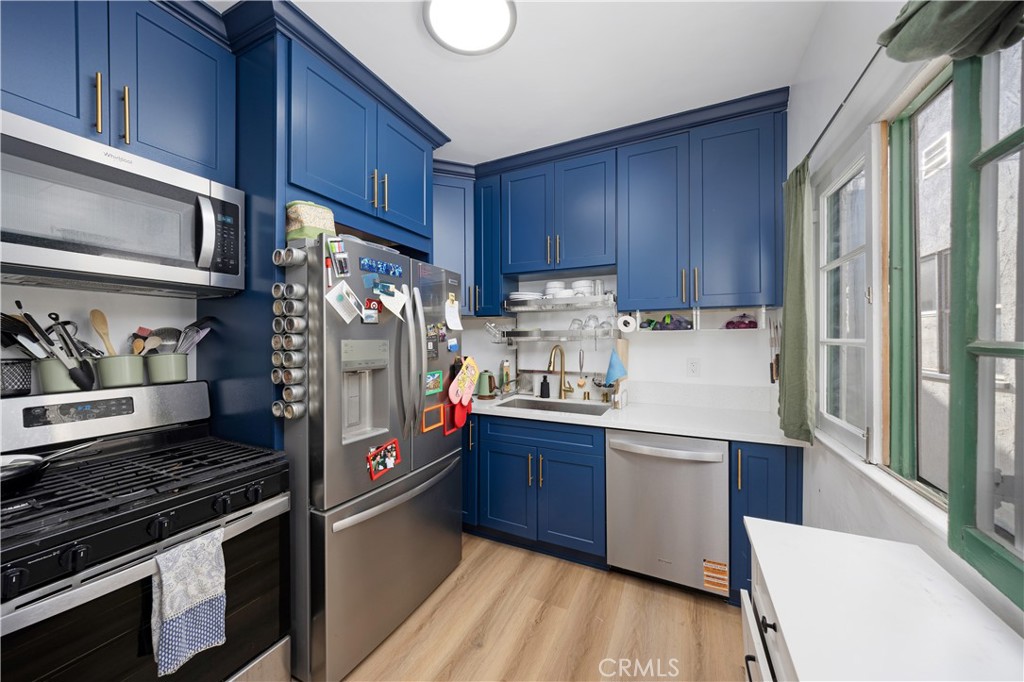 28 Argonne Avenue Long Beach, CA 90803 - Photo 7 of 20 a kitchen with stainless steel appliances granite countertop a stove and a refrigerator