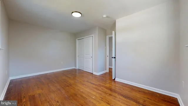 a bathroom with a granite countertop toilet sink and mirror