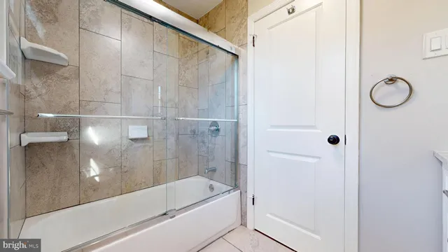 an empty room with wooden floor and window