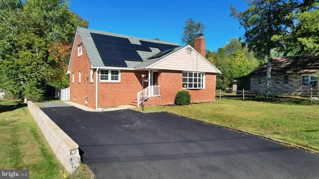 a front view of house with yard and trees around
