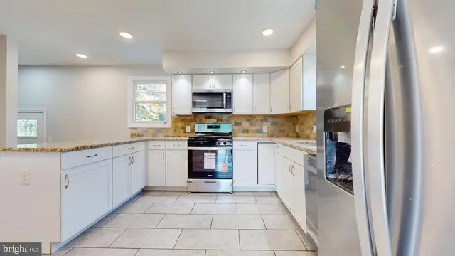 a kitchen with a sink a stove top oven and cabinets
