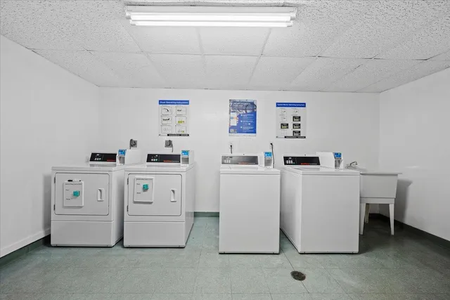 a utility room with cabinets washer and dryer