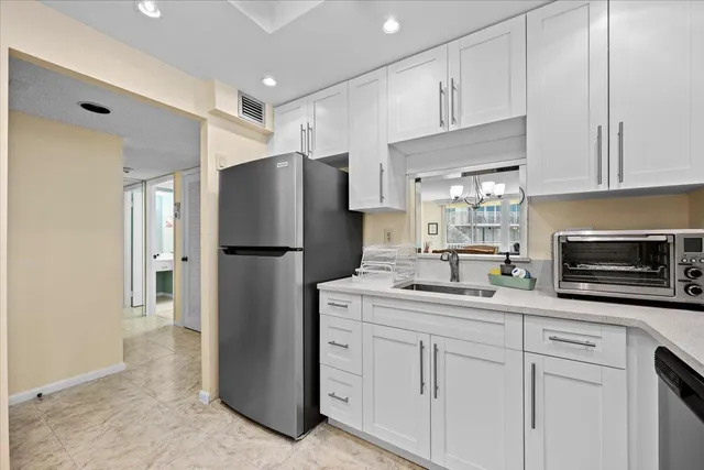 a kitchen with stainless steel appliances a refrigerator sink and microwave