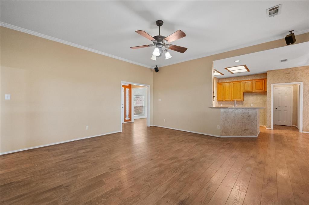 5250 Plainview Road Midlothian, TX 76065 - Photo 14 of 37 an empty room with wooden floor fan and windows