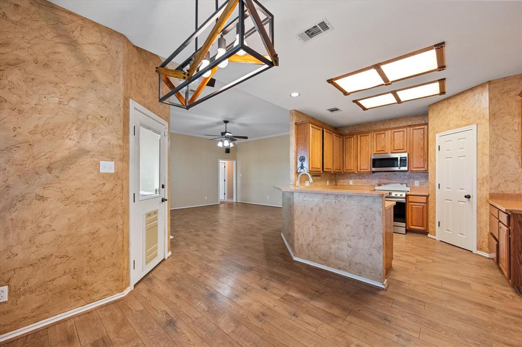 5250 Plainview Road Midlothian, TX 76065 - Photo 22 of 37 a view of a kitchen with a sink and a refrigerator