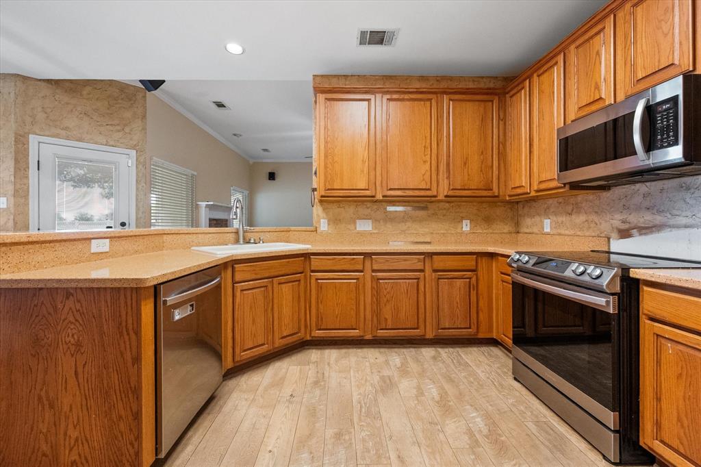 5250 Plainview Road Midlothian, TX 76065 - Photo 25 of 37 a kitchen with stainless steel appliances granite countertop a sink stove and microwave