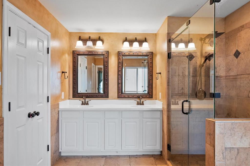 5250 Plainview Road Midlothian, TX 76065 - Photo 30 of 37 a bathroom with double vanity sinks a mirror and a shower
