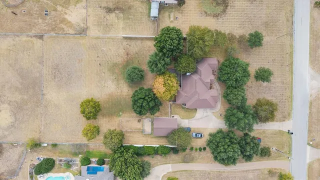an aerial view of a house with garden space and street view