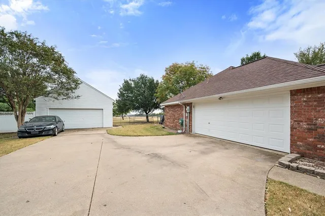 a view of a house with a yard and garage
