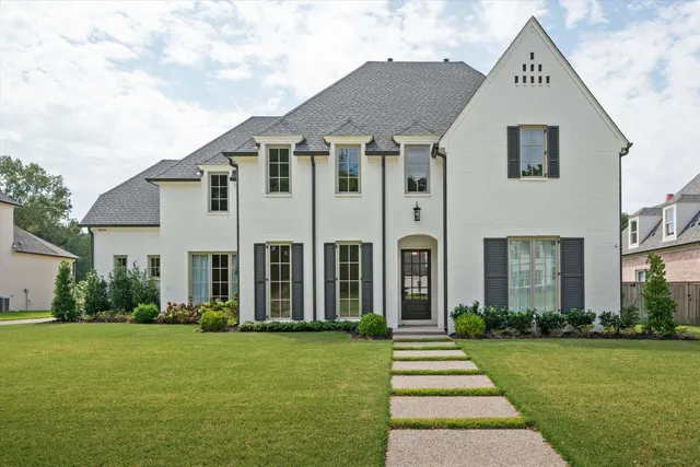 a front view of a house with a garden