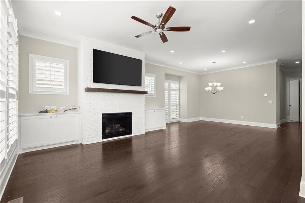 293 Thompson Street Alpharetta, GA 30009 - Photo 11 of 71 an empty room with windows fireplace and a flat screen tv