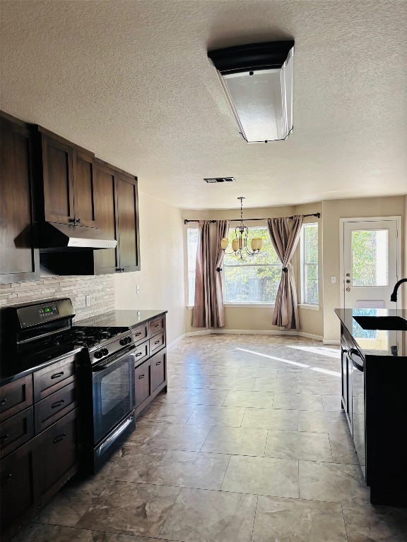 714 Adler Falls Lane Round Rock, TX 78665 - Photo 5 of 18 a kitchen with stainless steel appliances granite countertop a stove a sink and a microwave