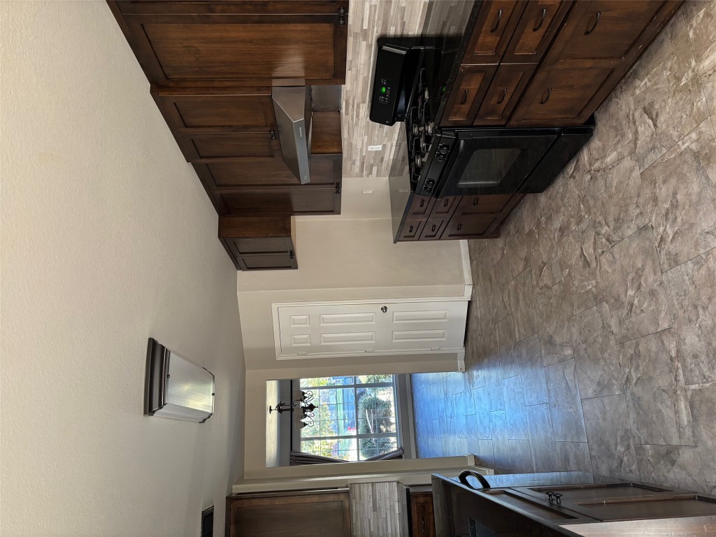 714 Adler Falls Lane Round Rock, TX 78665 - Photo 6 of 18 a kitchen with stainless steel appliances granite countertop a stove sink and cabinets