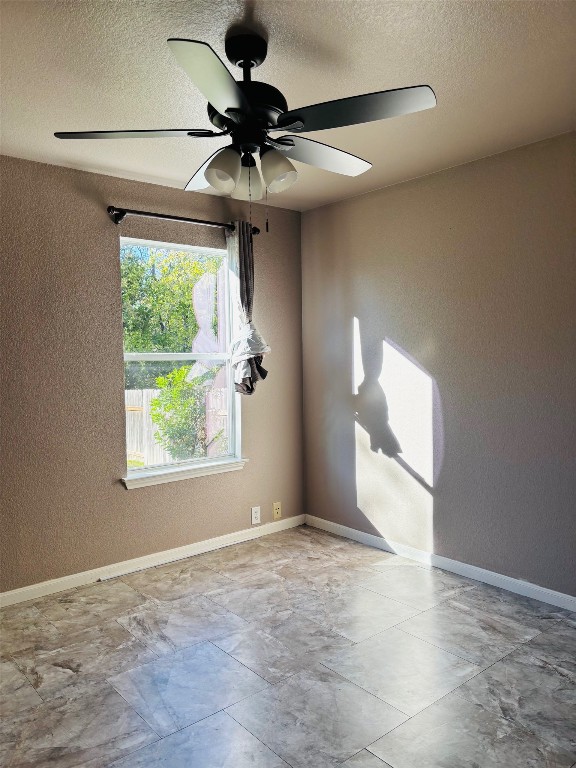 714 Adler Falls Lane Round Rock, TX 78665 - Photo 8 of 18 a view of an empty room and window and chandelier fan